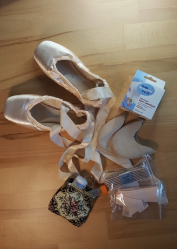 My pointe shoes, toe pads, tape and sewing tool.